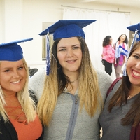 Three students taking picture at GradFest